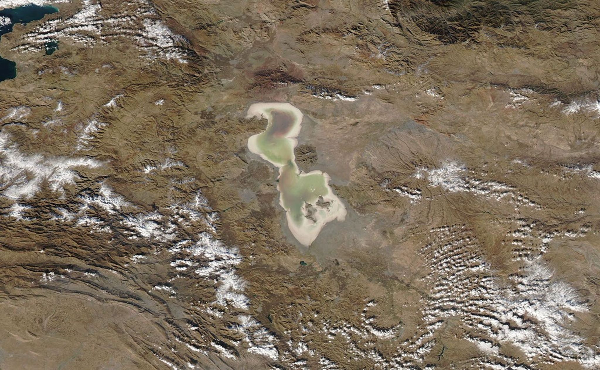 Iran's Lake Urmia is one of the world's largest hypersaline (extremely salty) lakes. It has been declared a Wetland of International Importance and a UNESCO Biosphere Reserve. But as reported by the United Nations Environment Programme, its water level began to decline rapidly in the mid-1990s. Incoming water was diverted for agricultural use, dams blocked inflowing rivers, rainfall decreased, and rising temperatures brought increased evaporation. Torrential rains in 2018 and 2019 helped to replenish the lake, as seen in the June image, which shows Urmia largely filled with water tinted red by bacteria or algae. But by the time of the November image, the lake was once again drying out. Read more at NASA's Earth Observatory.   Images taken by the Moderate Resolution Imaging Spectroradiometer (MODIS) instrument on NASA's Aqua satellite. Source: NASA's Earth Observatory   Download images:image 1image 2