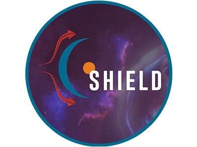 A round identifier that includes deep purples and heliopsheric elements and the word SHIELD