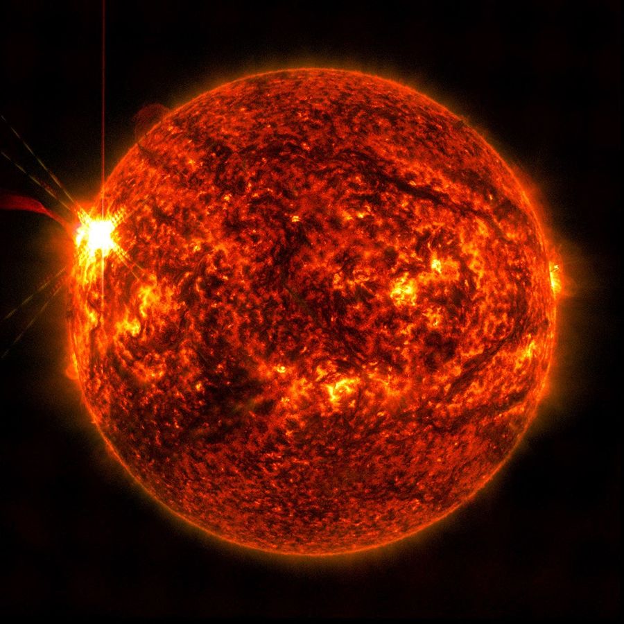 Extreme ultraviolet image of the Sun showing the bright flash of a solar flare on the left side