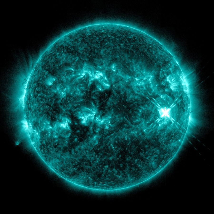 An extreme ultraviolet view of the Sun shows the bright flash of a solar flare on the Sun's right side