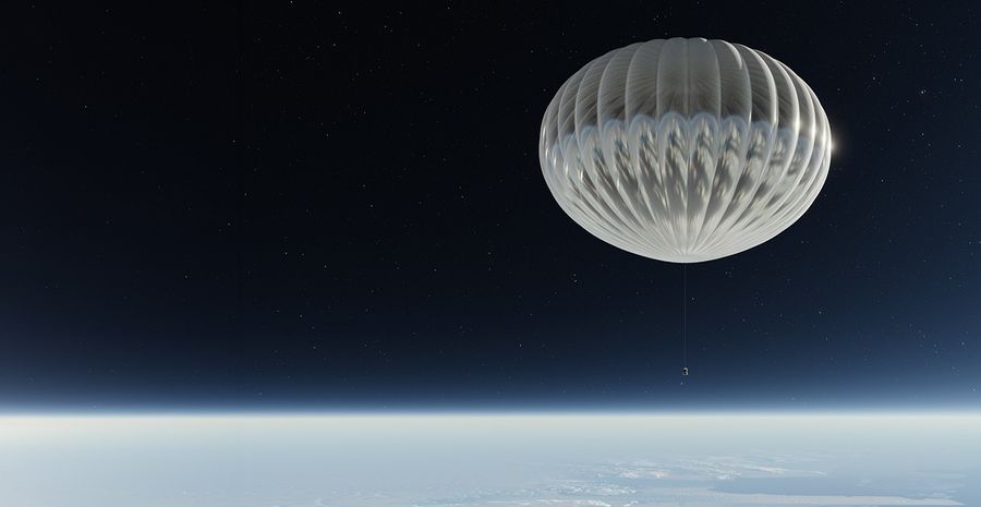 This image depicts the ASTHROS mission in flight in over Antarctica. The mission’s launch vehicle, an American football-stadium sized stratospheric balloon, and telescope payload fly in the stratosphere. Clouds and Antarctic land are visible below the mission, while the  vast expanse of outer space stretches above the mission.