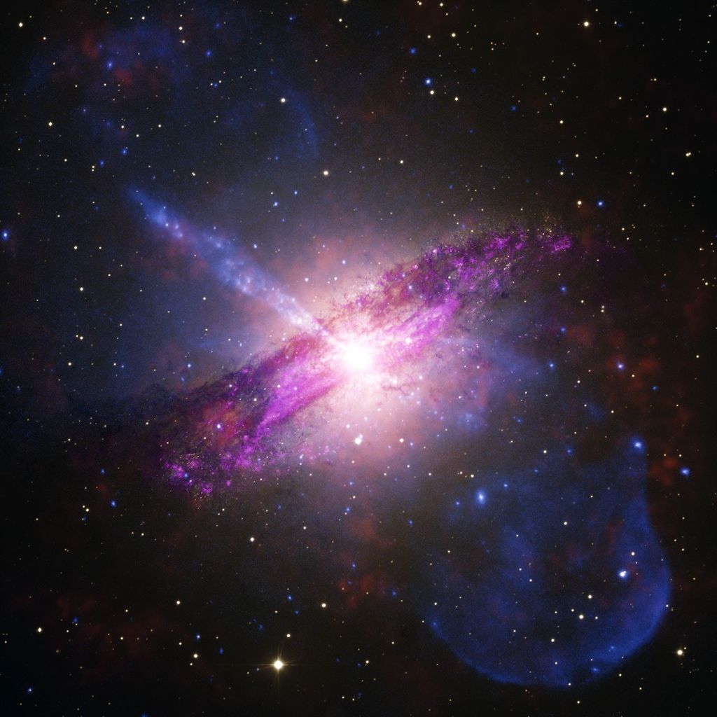 A giant elliptical galaxy undergoing a dusty merger, featuring a powerful jet of particles blasting tens of thousands of light-years into space. Chandra’s X-rays (blue) showcase the high-energy jet, with additional X-rays from IXPE (orange), while Webb infrared (magenta) and optical light (amber and white) from the European Southern Observatory expose a dark, churning dust lane. As one of the closest active galaxies to Earth, Cen A allows astronomers to study the effects of supermassive black hole jets in extraordinary detail.