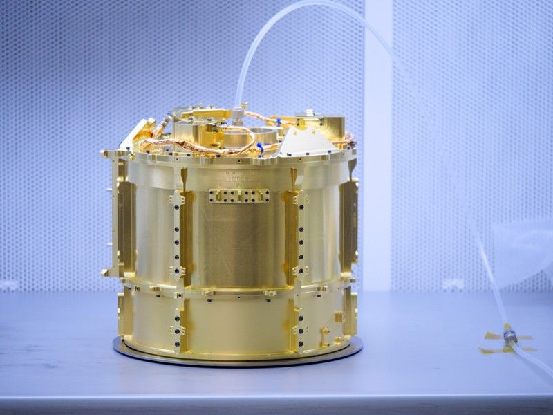 An image showing an engineer handles the SUrface Dust Analyzer (SUDA) in the clean room at the Laboratory for Atmospheric and Space Physics (LASP) at the University of Colorado Boulder. Dry nitrogen gas is continually pumped through the instrument during assembly and testing to ensure it remains clean and free of contaminants.