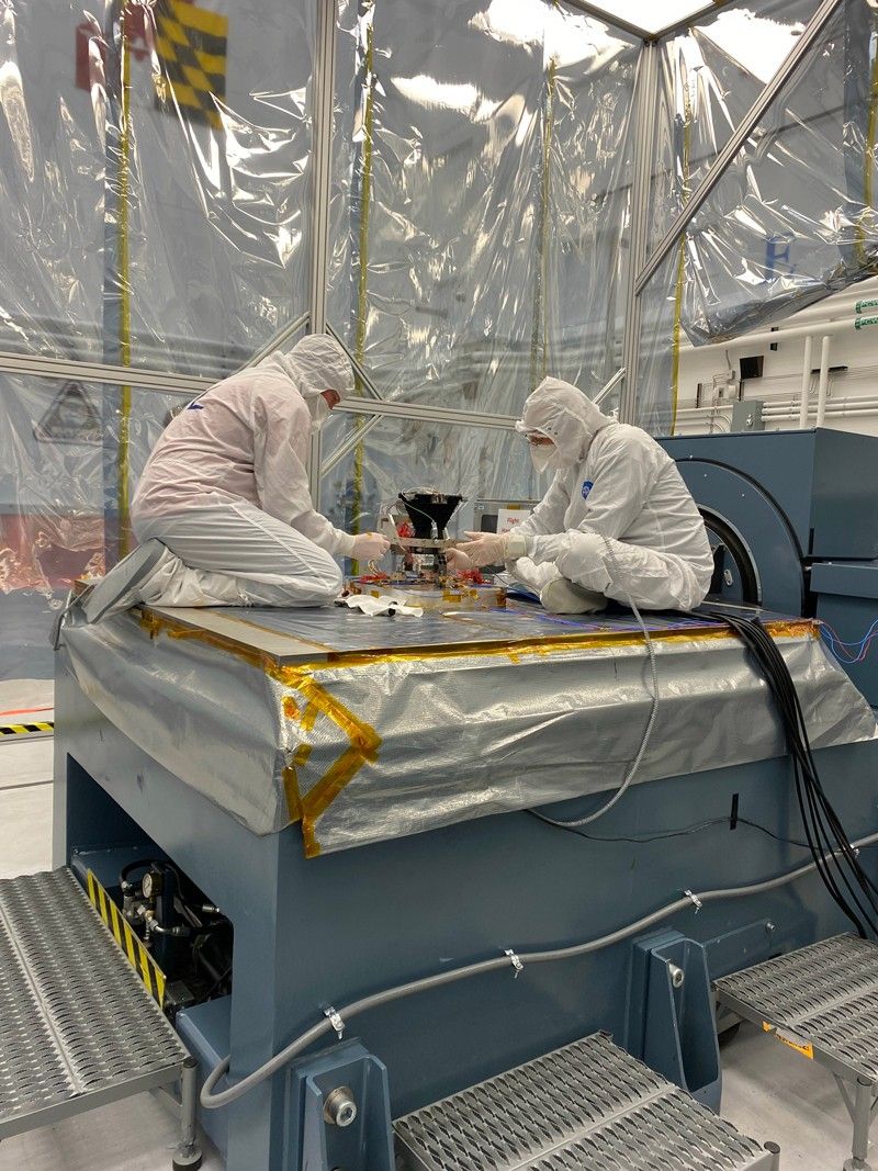 Two engineers in a cleanroom at the Johns Hopkins University Applied Physics Laboratory assemble sensors for Europa Clipper's image system's wide angle camera for vibration testing.