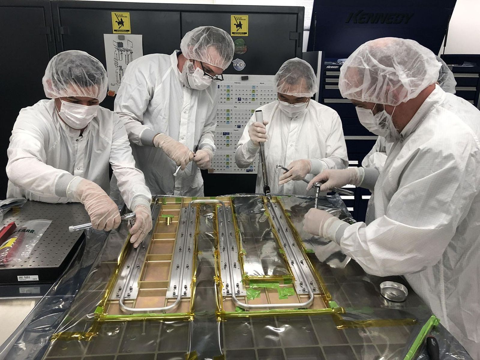 Members of the Europa Clipper team work on the spacecraft’s heat redistribution system at Jet Propulsion Laboratory in 2019.