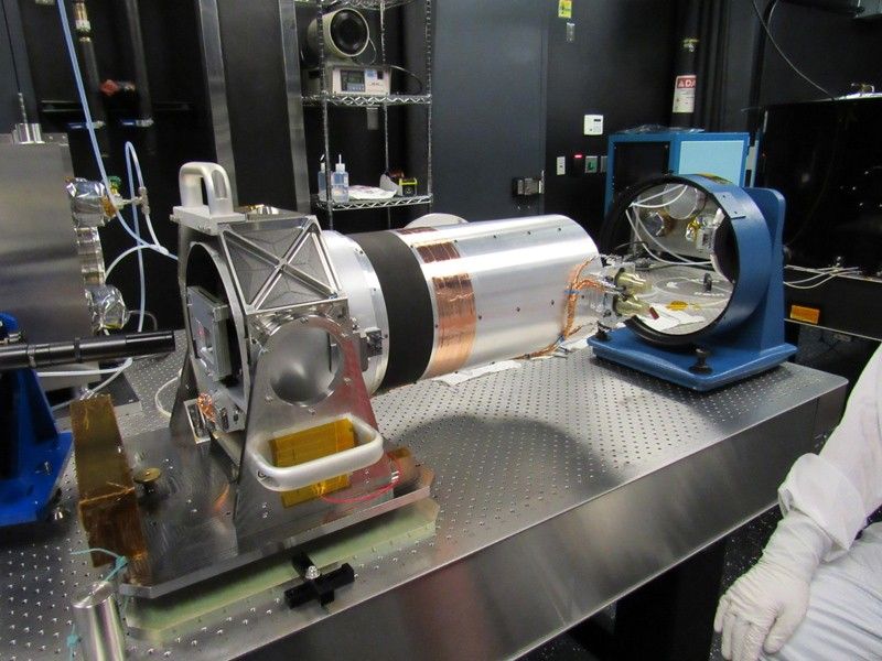 An engineer performs wavefront tests on the optical telescope assembly for the Europa Imaging System narrow angle camera.