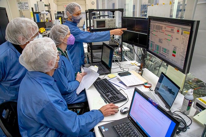 Southwest Research Institute (SwRI) staff collaborate on the calibration of the MAss Spectrometer for Planetary EXploration/Europa (MASPEX) instrument, developed and built at SwRI. Kurt Franke (spectrometer engineering lead) points out a mass peak during the MASPEX flight model first calibration run to, clockwise, Kelly Miller (calibration lead), Greg Miller (spectrometer design lead), and Paul Hoeper (software lead).