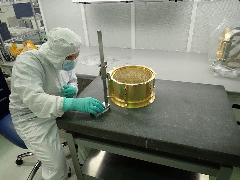 Marc Miller, a mechanical assembly technician at the University of Colorado Boulder Laboratory for Atmospheric and Space Physics (LASP), gauges the depth of ceramic pins installed in the SUrface Dust Analyzer (SUDA) instrument.