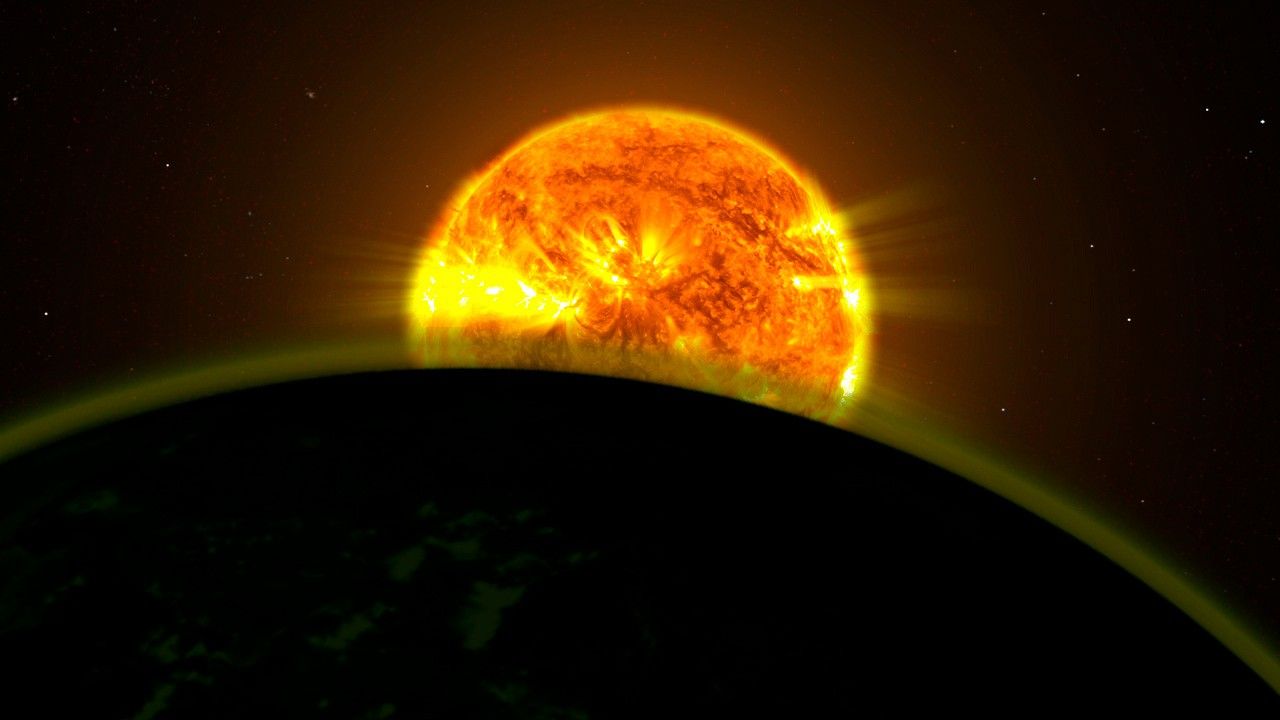 The arc of part of a planet takes up the foreground on the lower half of the screen, appearing dark green with a light green haze emerging from it. In the center, partially concealed from sight by the arc of the planet, is an orange star appearing as a molten ball of fire.