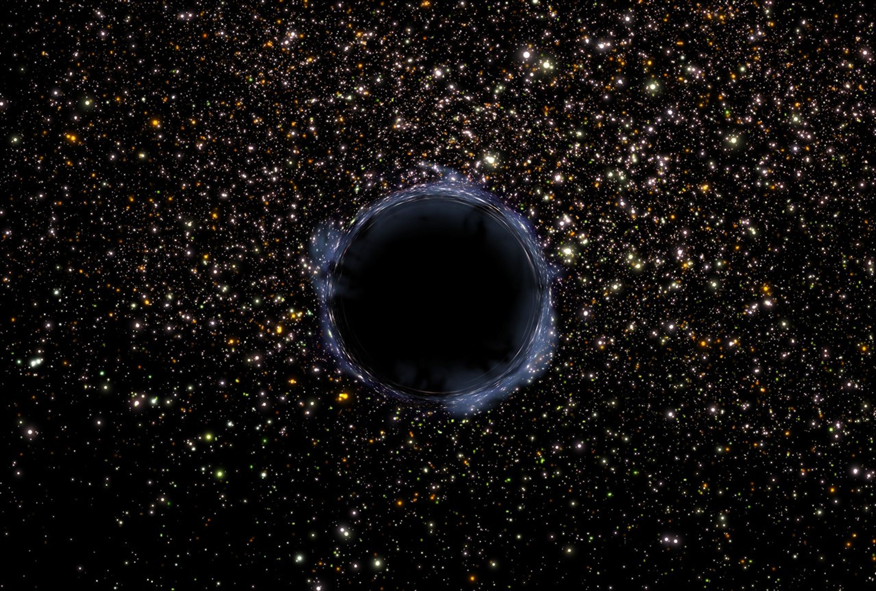 A plethora of multicolored stars against the black backdrop of space, with the stars more concentrated near the center of the image and in the top half, and more scattered in the bottom half. In the center is a large black-and-gray sphere representing the black hole, with the space immediately surrounding it forming a whitish, distorted arc.