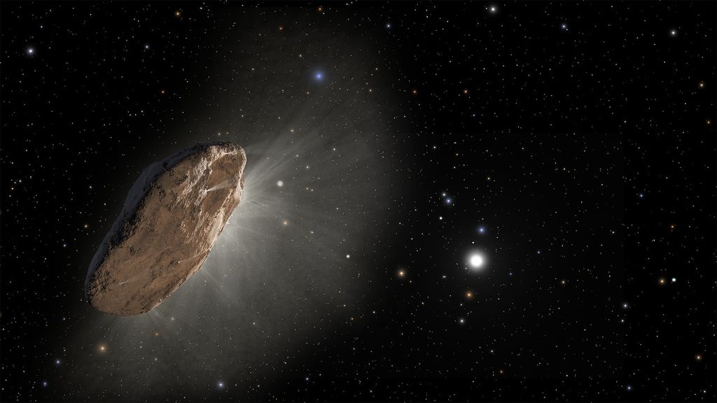 On the left is a light brown object, shaped like a flat stone standing vertical, that releases a whitish haze on its right side. This is the side facing the Sun (a bit below and right of center). The background is the blackness of space, many dots of smaller stars, and brighter dots of other, nearer stars and other Solar System objects.