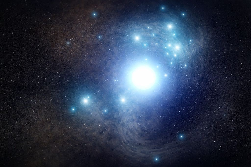 A blue-white star glows bright at the center, with two arcs of gas and dust to its upper right and lower right, shaped like a backward S together., with a darker haze of light brown to the star's left. A couple dozen more blue-white stars burn around it, mostly above it but a few below as well.