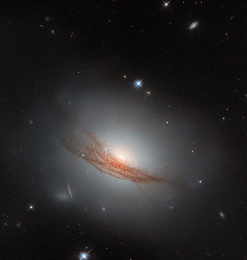 Hubble Sees Galaxy with Dark Rings in New Light