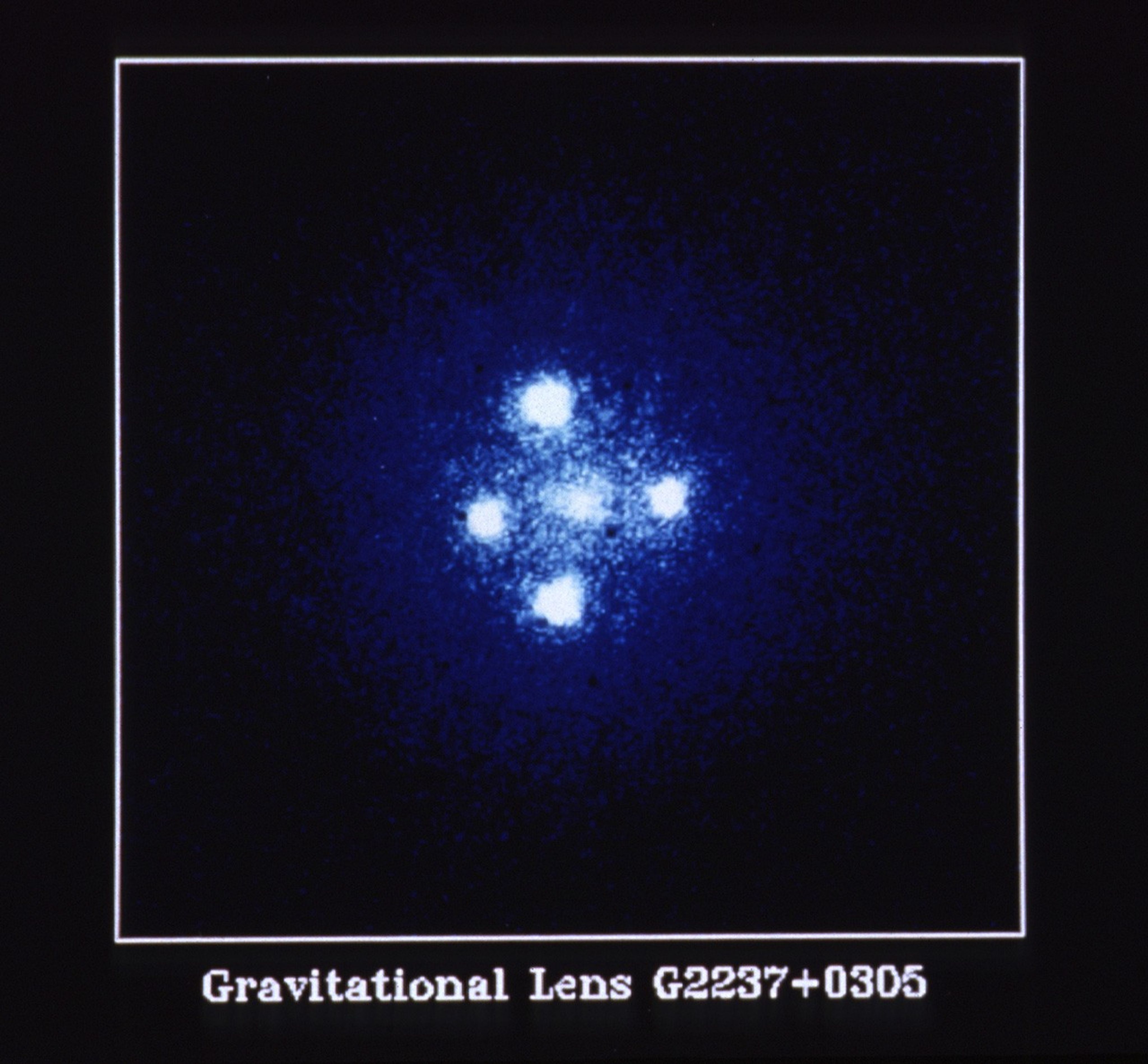 Four bright-white circles, positioned in the shape of a cross around a fifth more muted white spot in the center.