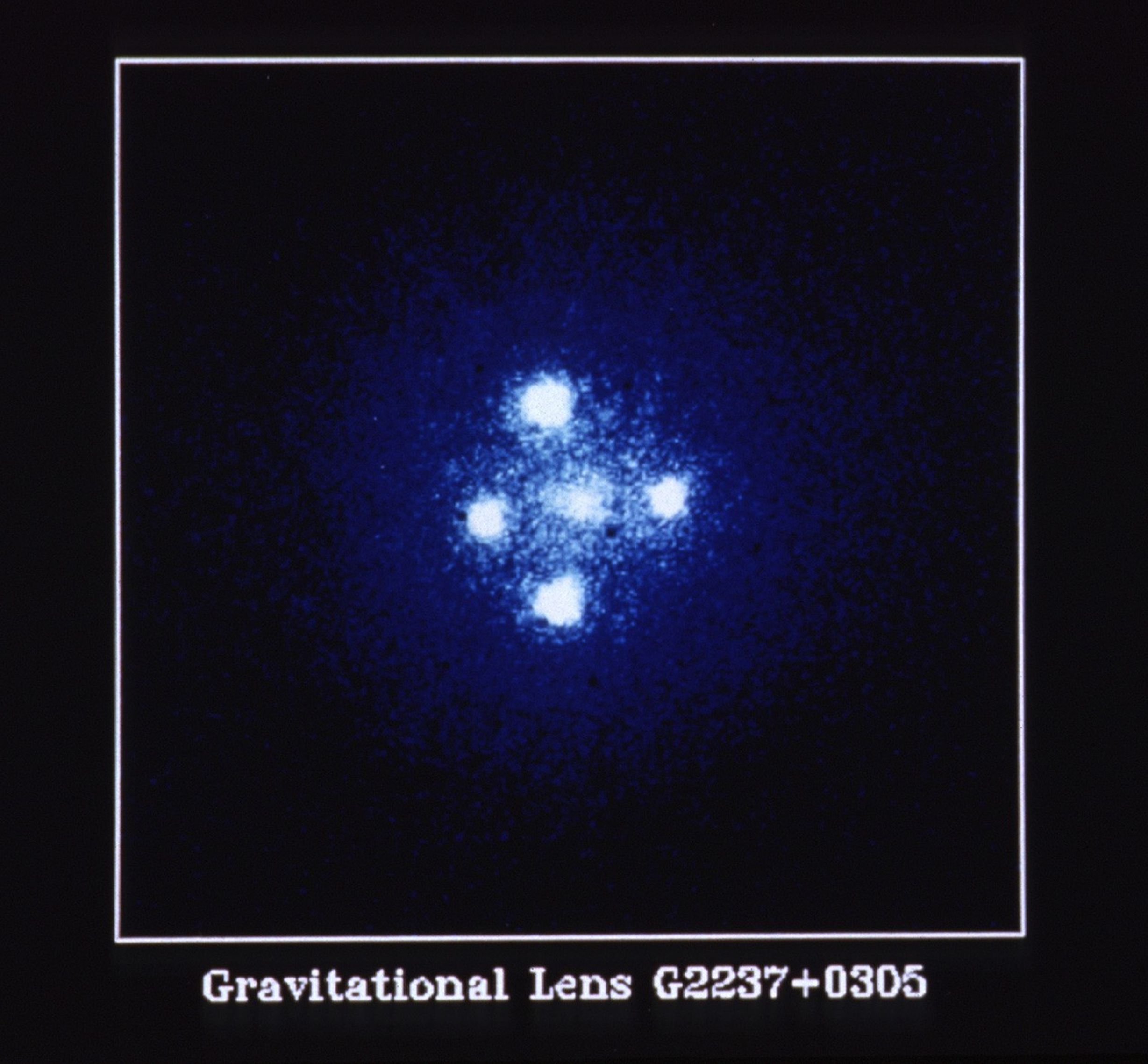 Four bright-white circles, positioned in the shape of a cross around a fifth more muted white spot in the center.