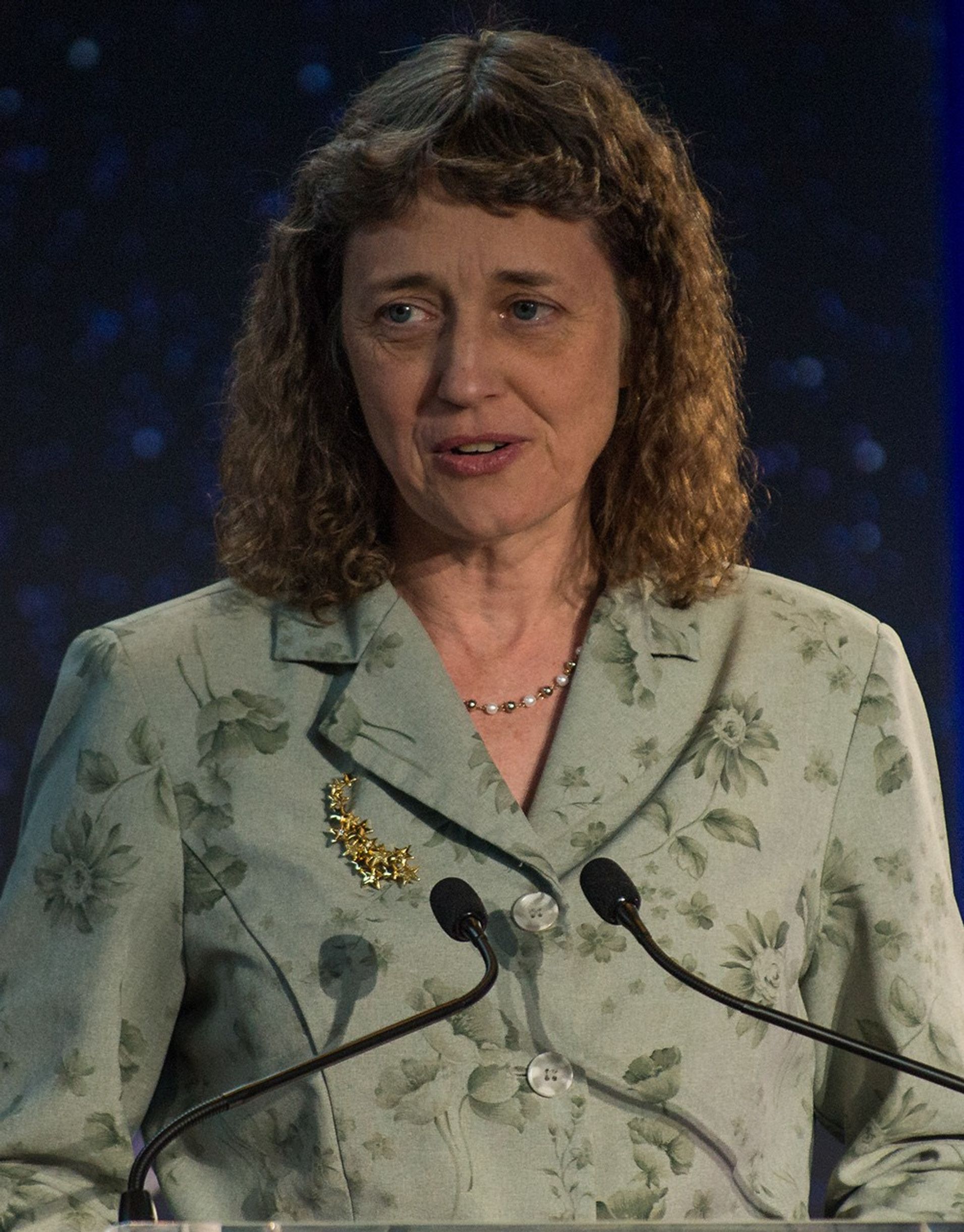 Dr. Jennifer Wiseman stands at the podium, addressing the audience.