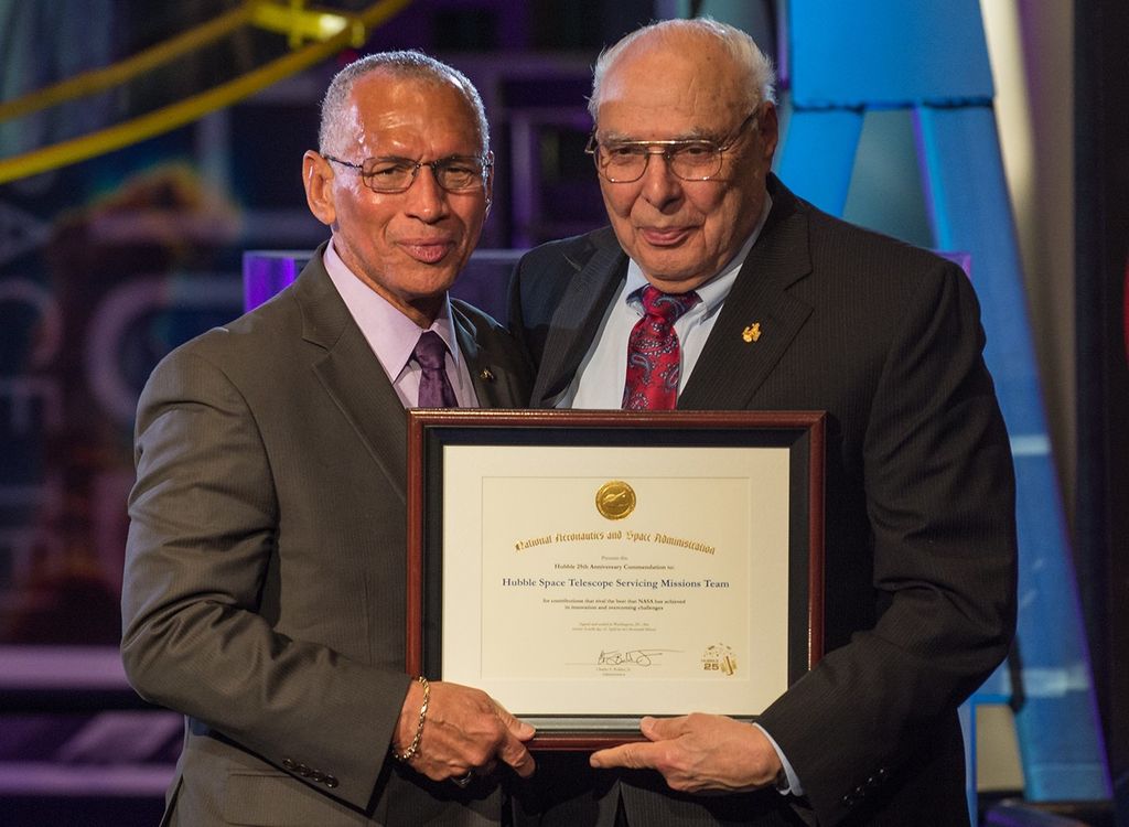 Charlie Bolden and Frank Cepolina stand side-by-side, both holding Cepolina's award with one hand each.