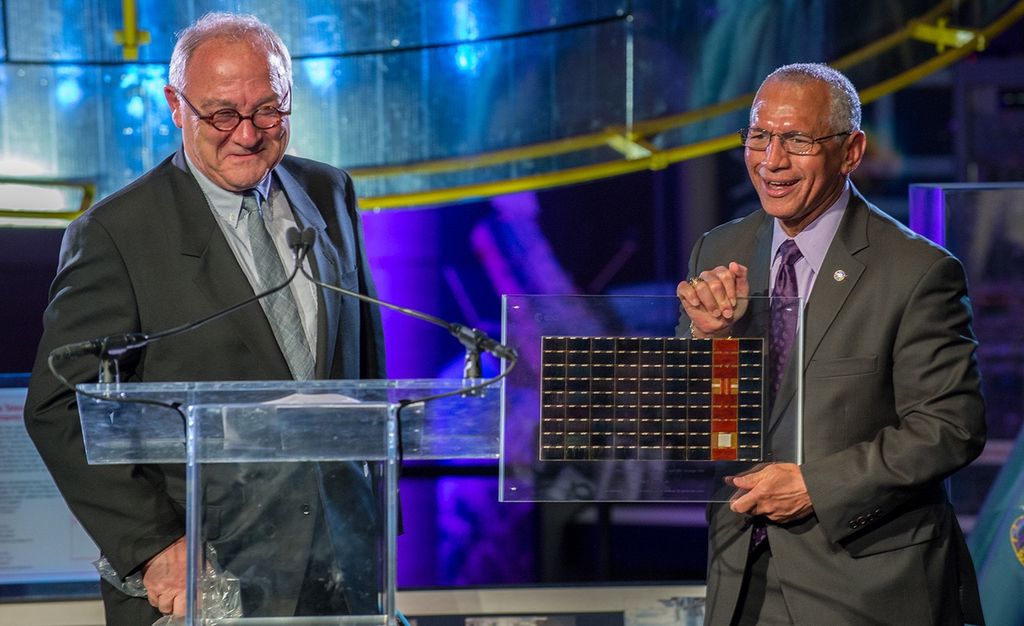 Bolden, right, holds a Hubble solar panel, while Dordain stands to the left.