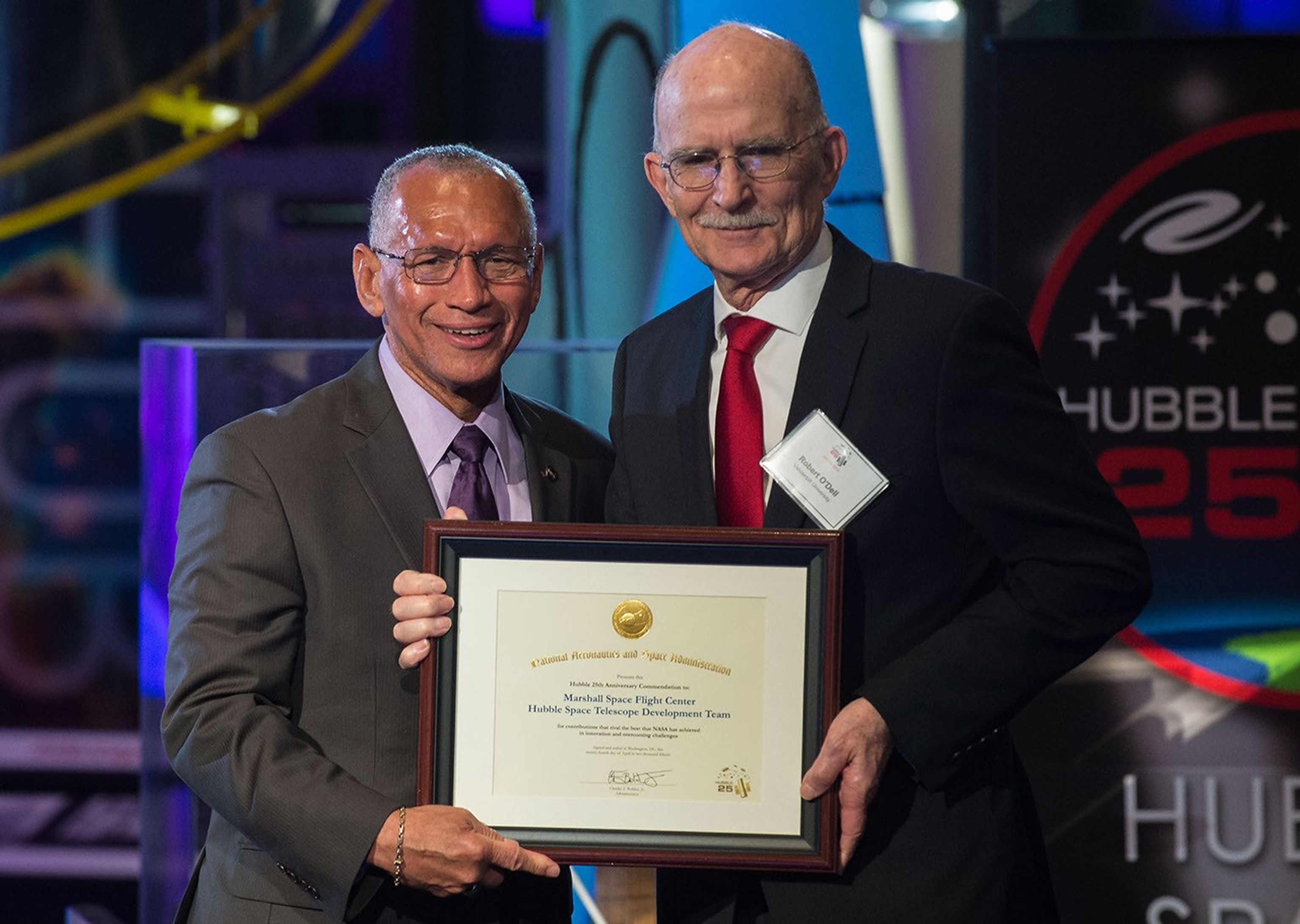 Charlie Bolden and Robert O'Dell stand side-by-side, both holding O'Dell's award.