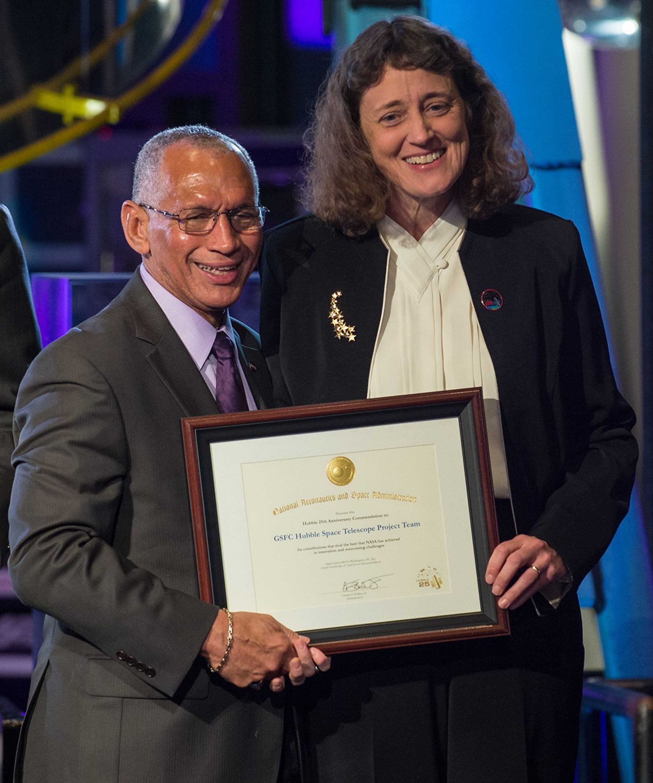 Charlie Bolden and Jennifer Wiseman stand side-by-side, both holding Dr. Wiseman's award.
