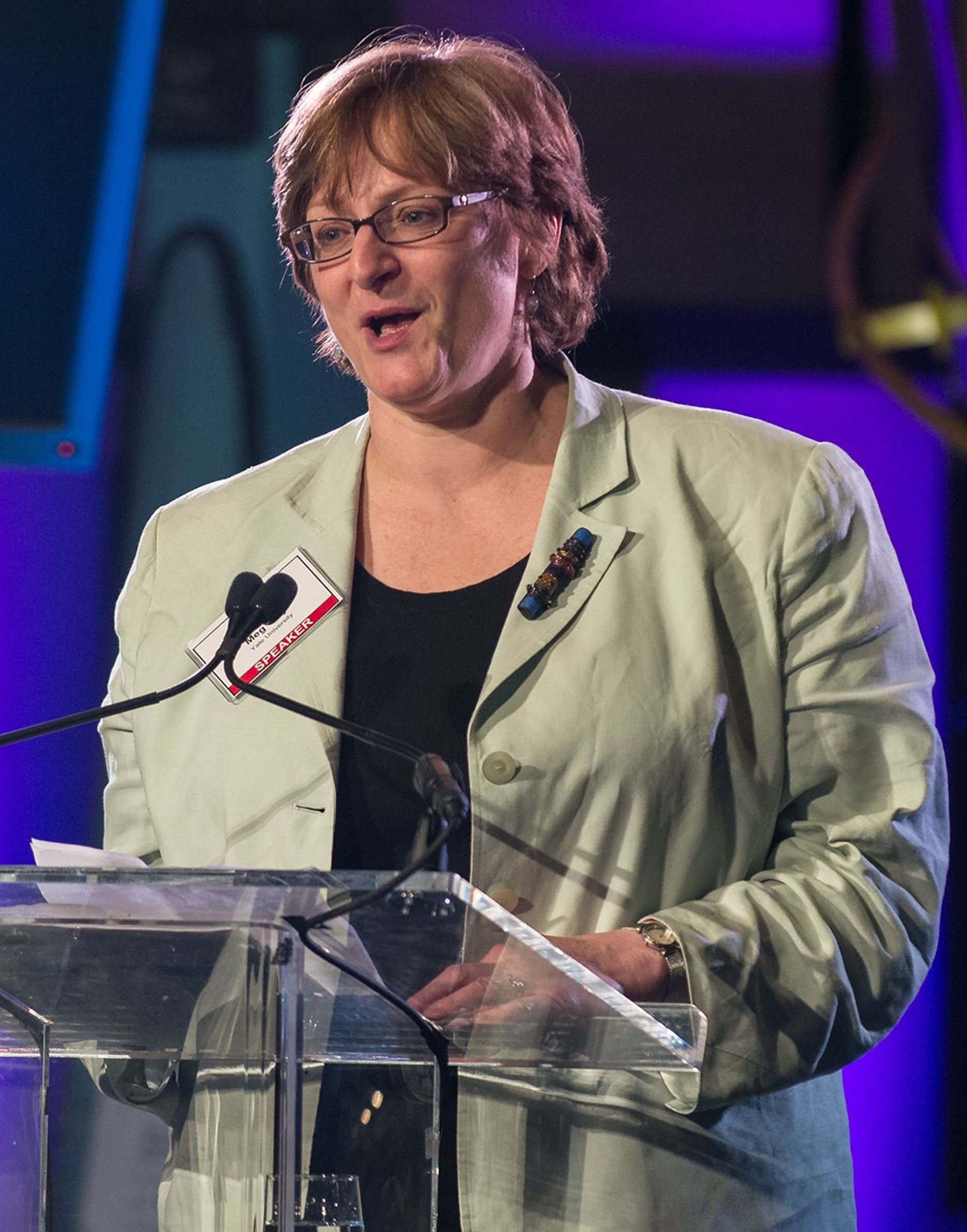 Meg Urry stands at the podium, addressing the audience.