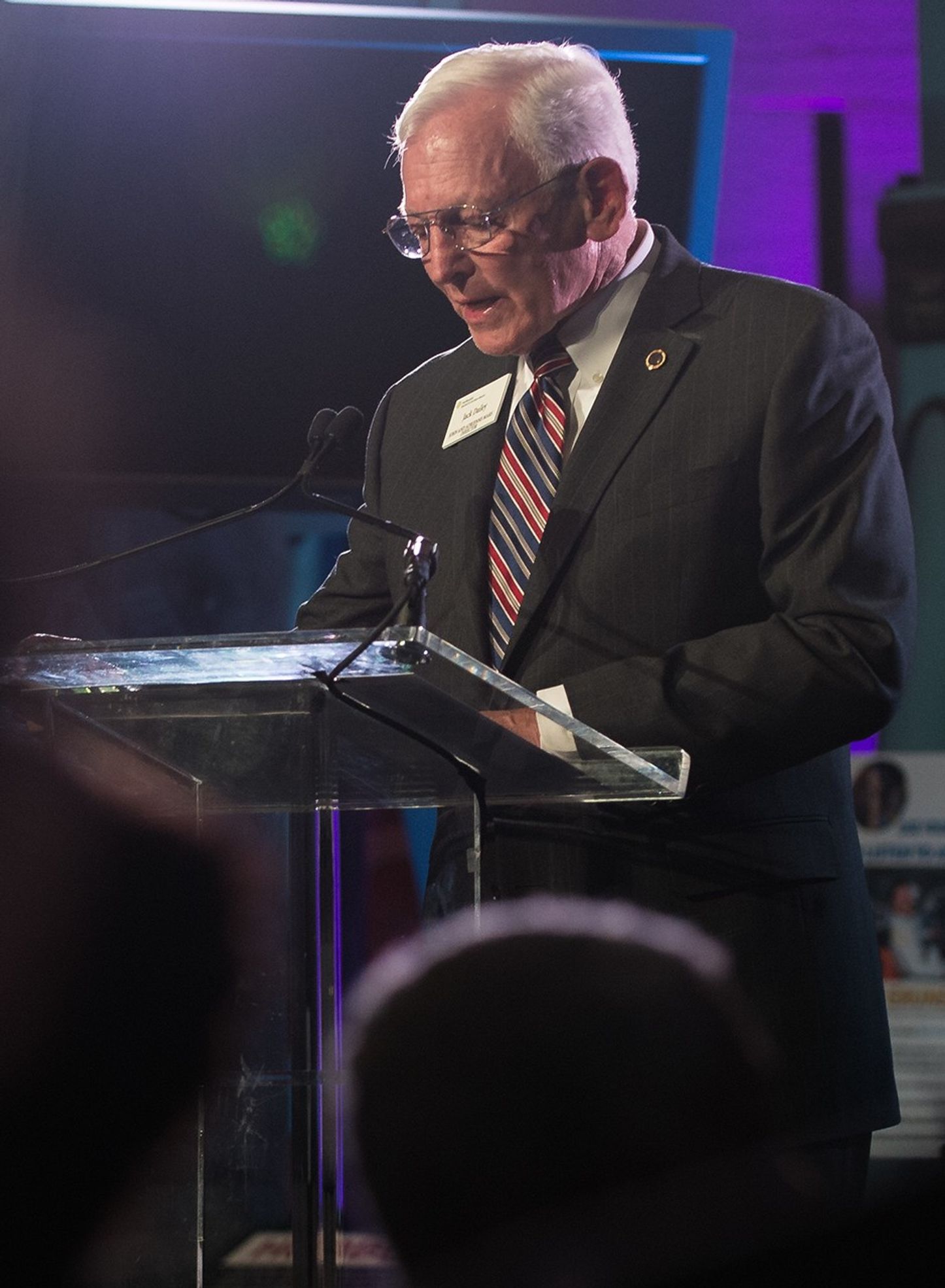 Jack Dalley stands at the podium, addressing the audience.