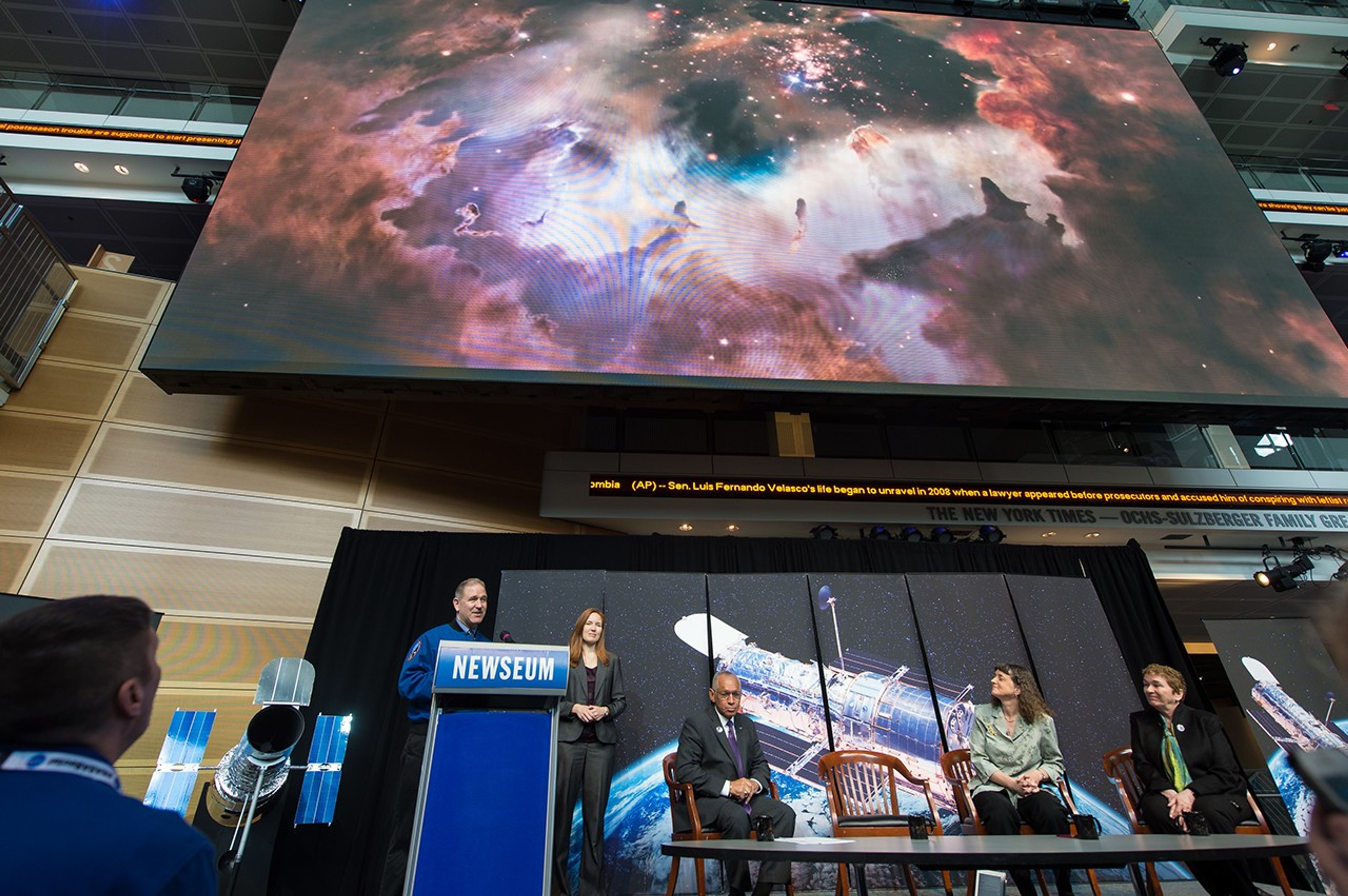 Onstage, John Grunsfeld unveils the anniversary image of Westerlund 2 on the big screen.