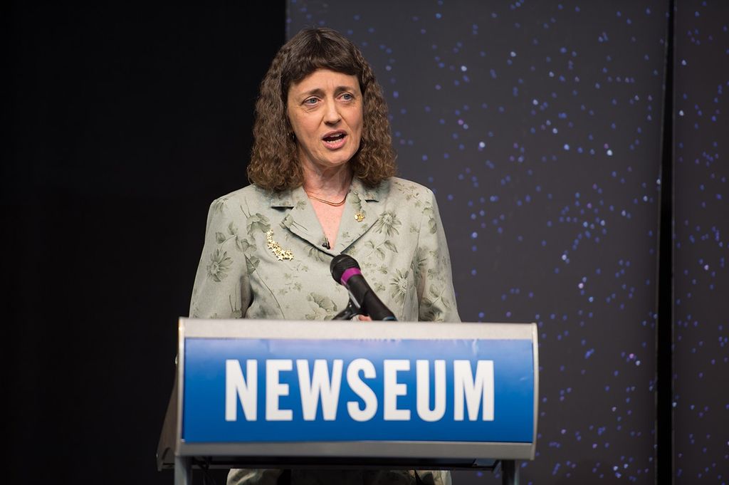 Dr. Jennifer Wiseman stands at the podium, addressing the audience.