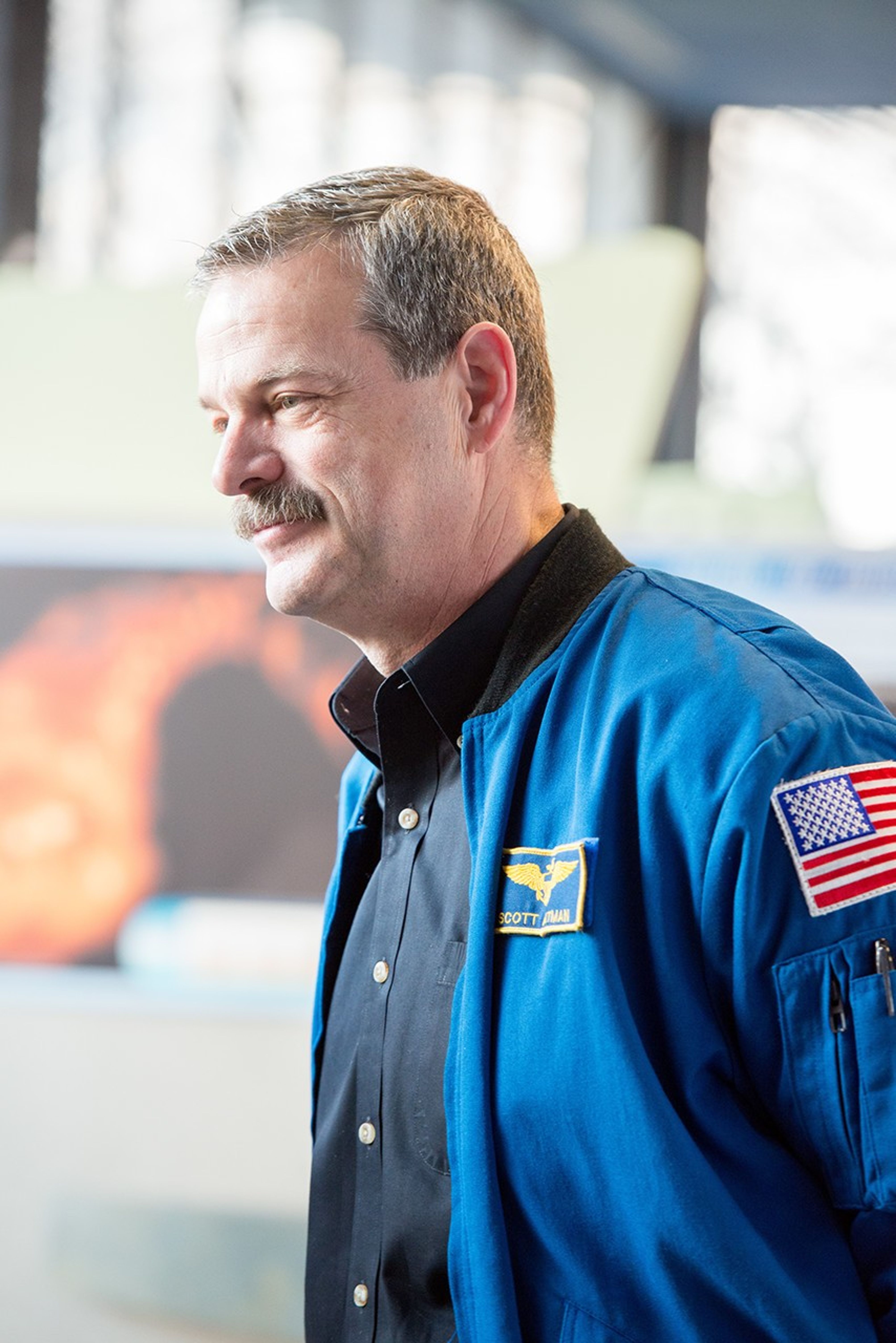 Scott Altman smiles and faces toward the left side of the image.