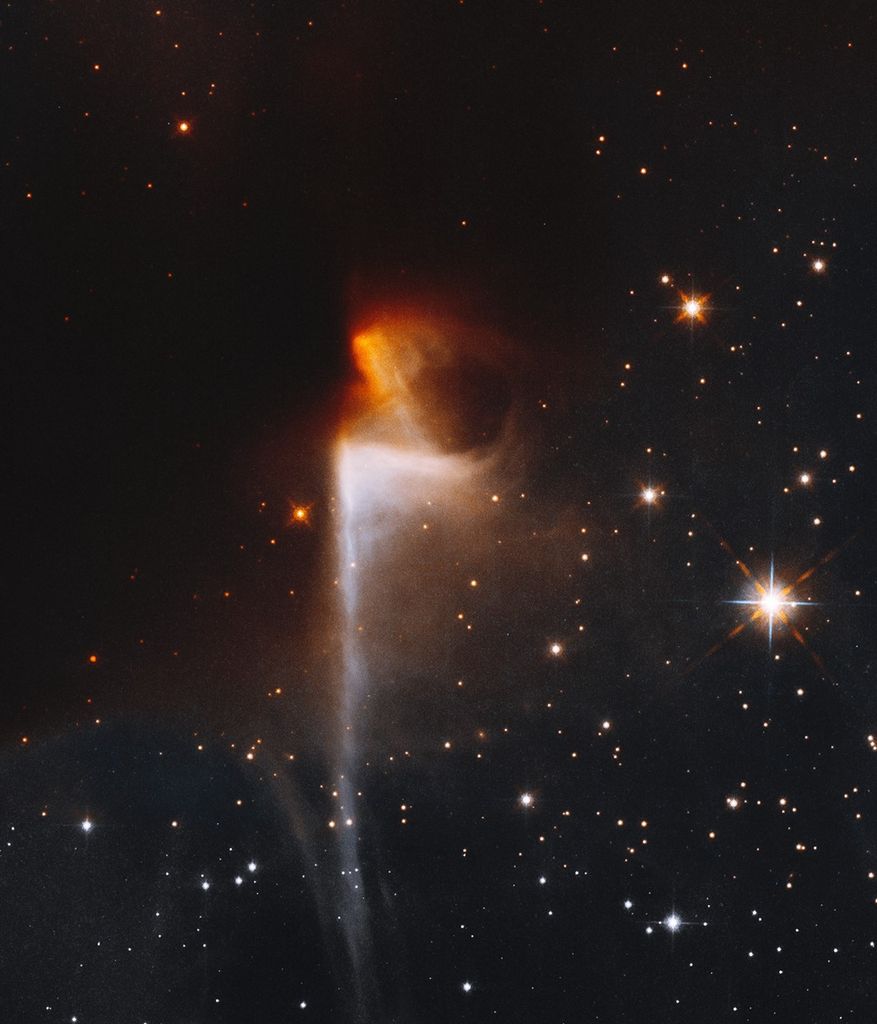Orange nebula emerges from dark nebula, with white nebula below stretching to the bottom of the image.