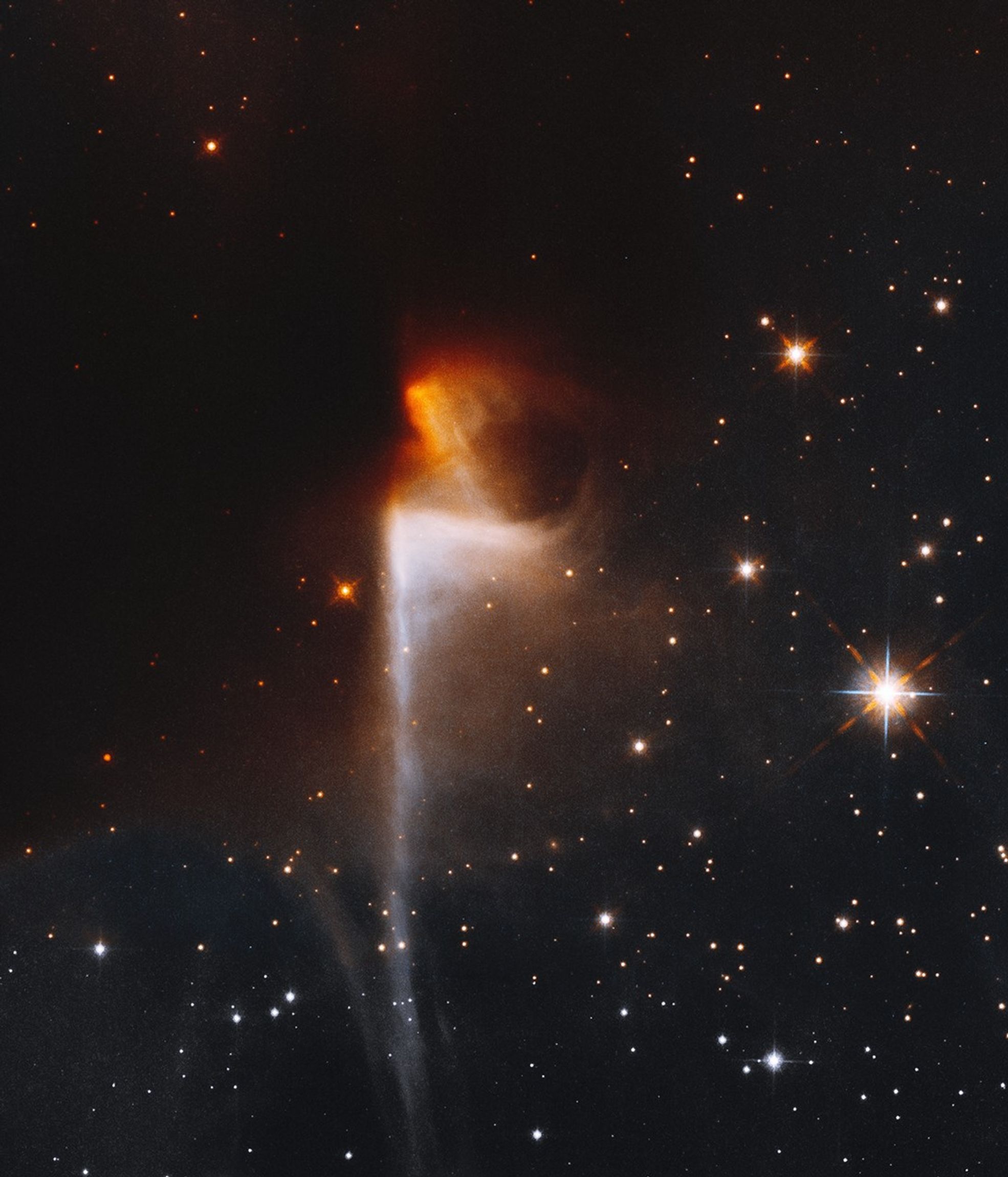 Orange nebula emerges from dark nebula, with white nebula below stretching to the bottom of the image.