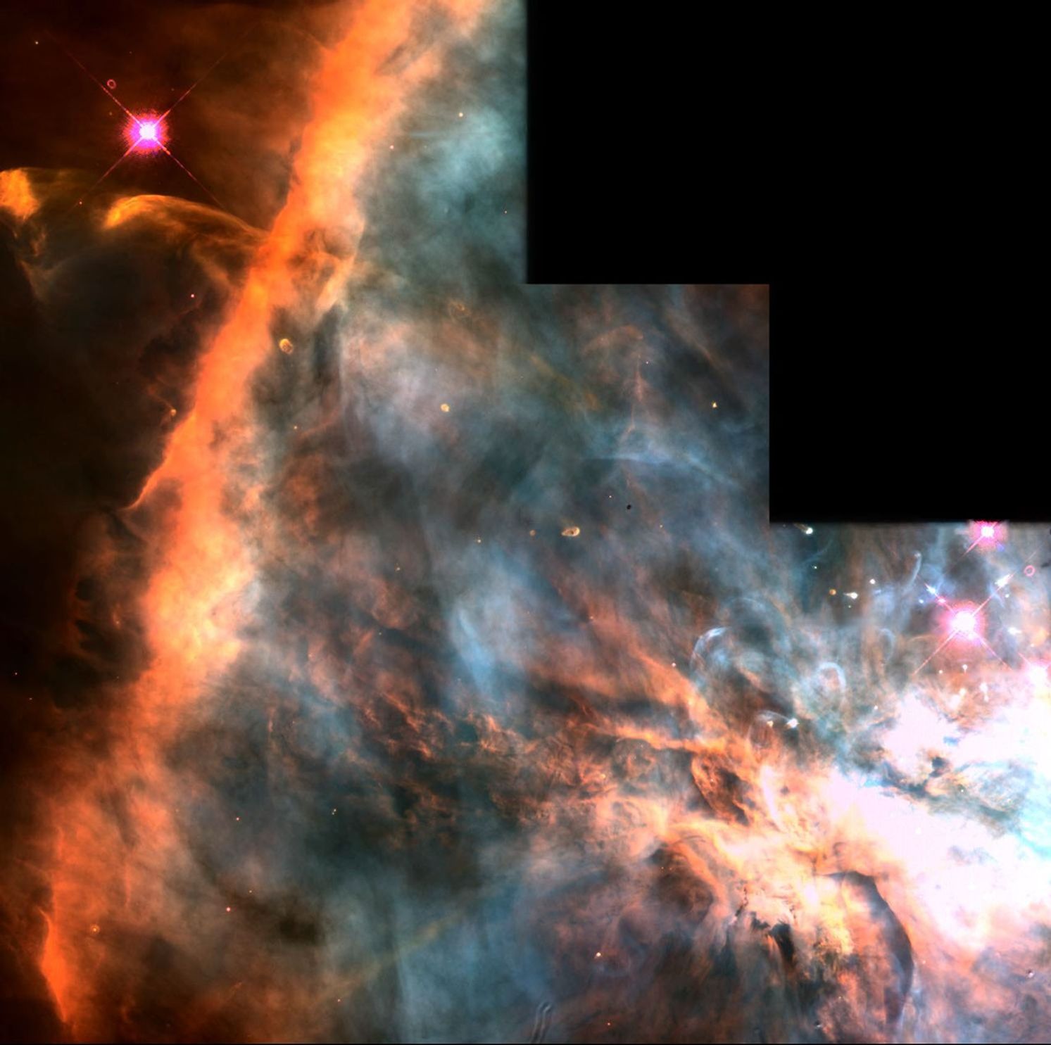 The image is "stairstepped" in the upper right (meaning that there's no image there. On the left, a bright orange streak of gas extends top to bottom, with a bright pink-red star in the upper-left. In the lower right is a bright white, orange, and yellow blob of gas that looks like an explosion. The area between this "explosion" and the orange streak is swirls of light blue gas with streaks of black and orange.