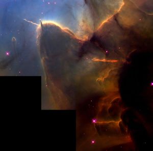 A tightly cropped Hubble view of a vast star-forming region known as the Trifid Nebula. The top left is bright blue. Brown and amber colors run from top right through the center in irregular, overlapping lines to the bottom-center. At bottom right, the view is almost black. Tiny, amber-colored stars appear throughout the scene. Toward the left there is a prominent brown shape that looks like a head with two horns. The left horn points left and is wavy. The right horn is triangular and points up. The brown dust continues, flowing down, as if along a back, and up toward the top right. A prominent line, about the same length as the left horn, appears below the middle of the body, and changes from orange to red. A small, separate semi-transparent pillar is left of the head. A few slightly larger, blue foreground stars with four diffraction spikes appear throughout.