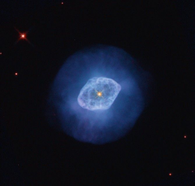 Bright blue nebula with a darker blue halo and a bright orange-yellow star at its center.