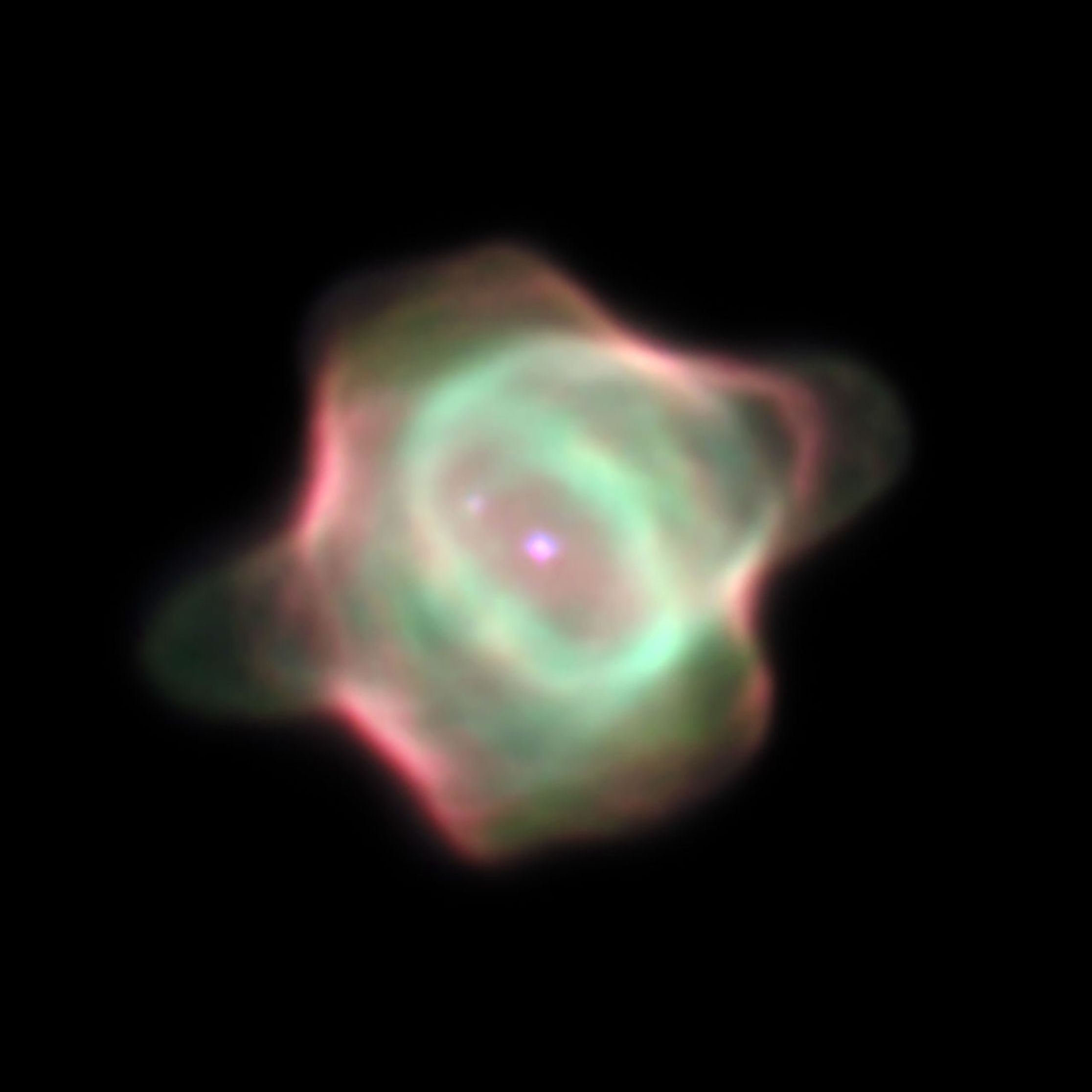 A stingray-shaped cloud of gas and dust. The star glowing at the center, and the very outer edges, are bright pink, while the gas in between is light green.