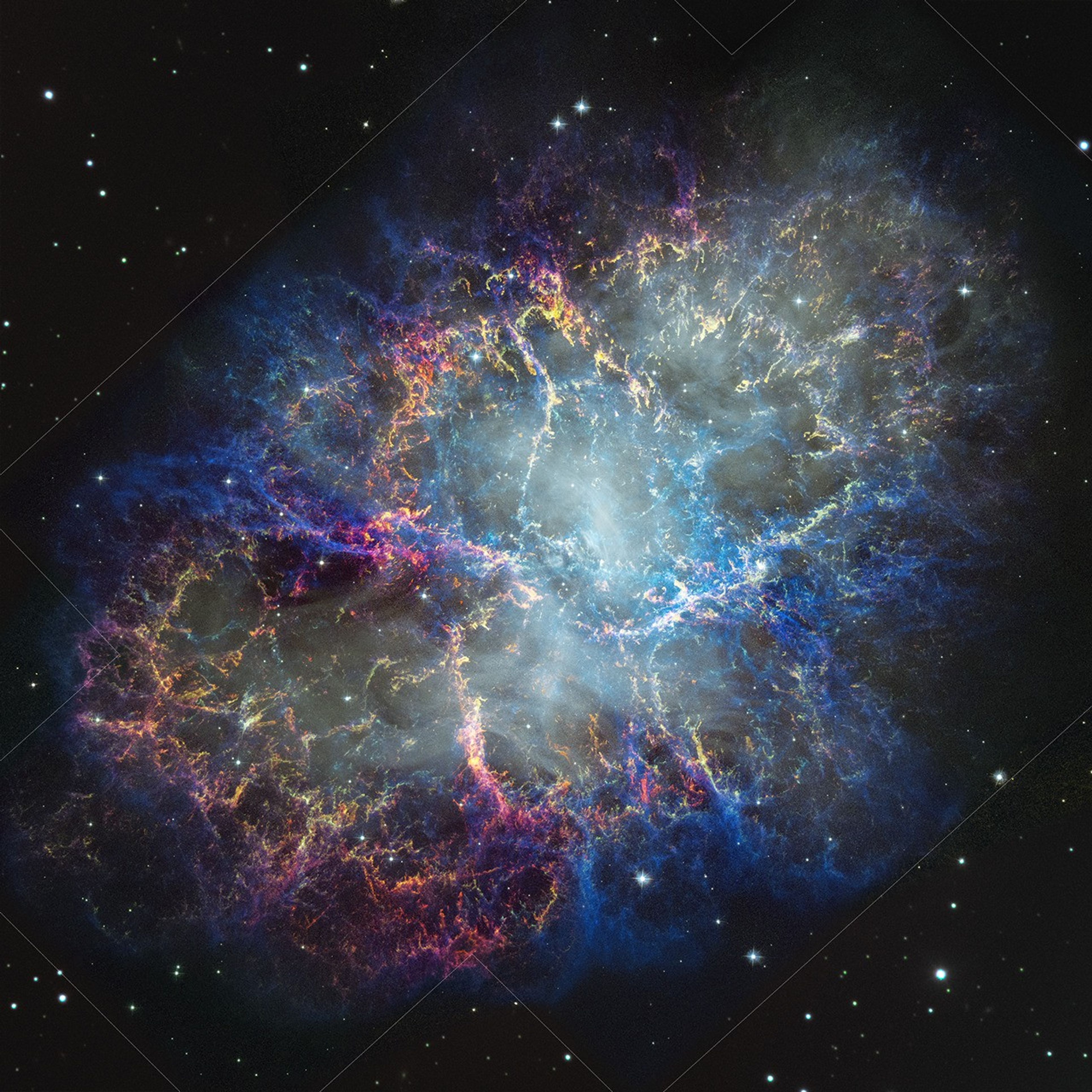 Colorful nebula in space with a white haze throughout that is more concentrated in the center with a rippling effect. Colorful gas filaments appear to splash outward from the nebula center, colored yellow, magenta, and blue. White stars dot the background.