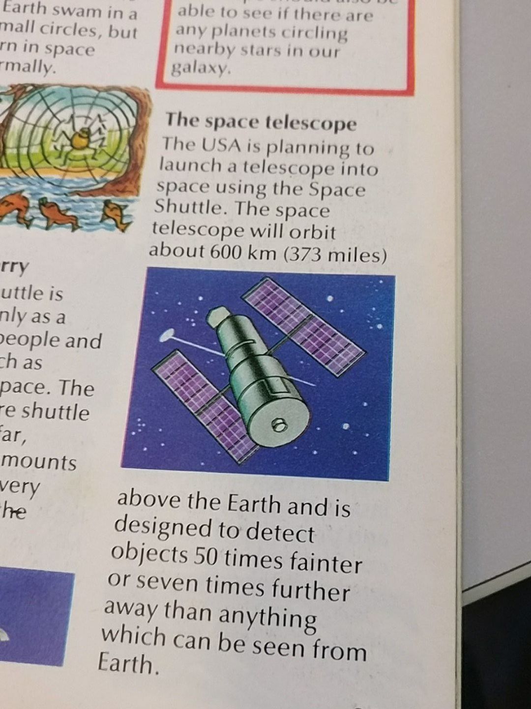 A picture of part of a page of a book. The text describes Hubble, which hasn't launched yet, with a cartoon image of what it will look like against a space background.