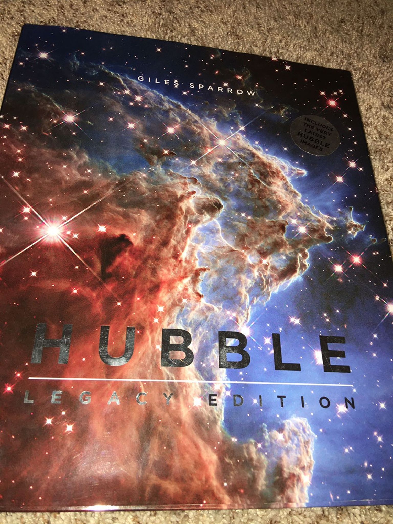 A book called "Hubble: Legacy Edition", with a beautiful image of a Hubble nebula on the front.