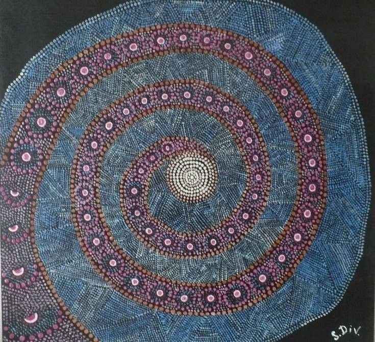Beaded artwork designed to look like a spiral galaxy on black background fabric. The center of the galaxy is light yellow, with pink spirals lacing out that are bordered by orange, and filled in/surrounded by light blue.