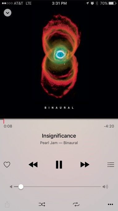 A screenshot of a song being played on a phone. The white lower half shows the play, pause, and volume buttons, along with the song info: Insignificance, by Pearl Jam, from the album Binaural. In the upper half is the album cover for Binaural, which is the Hubble image of the Hourglass Nebula with a blue eye transposed over the center.