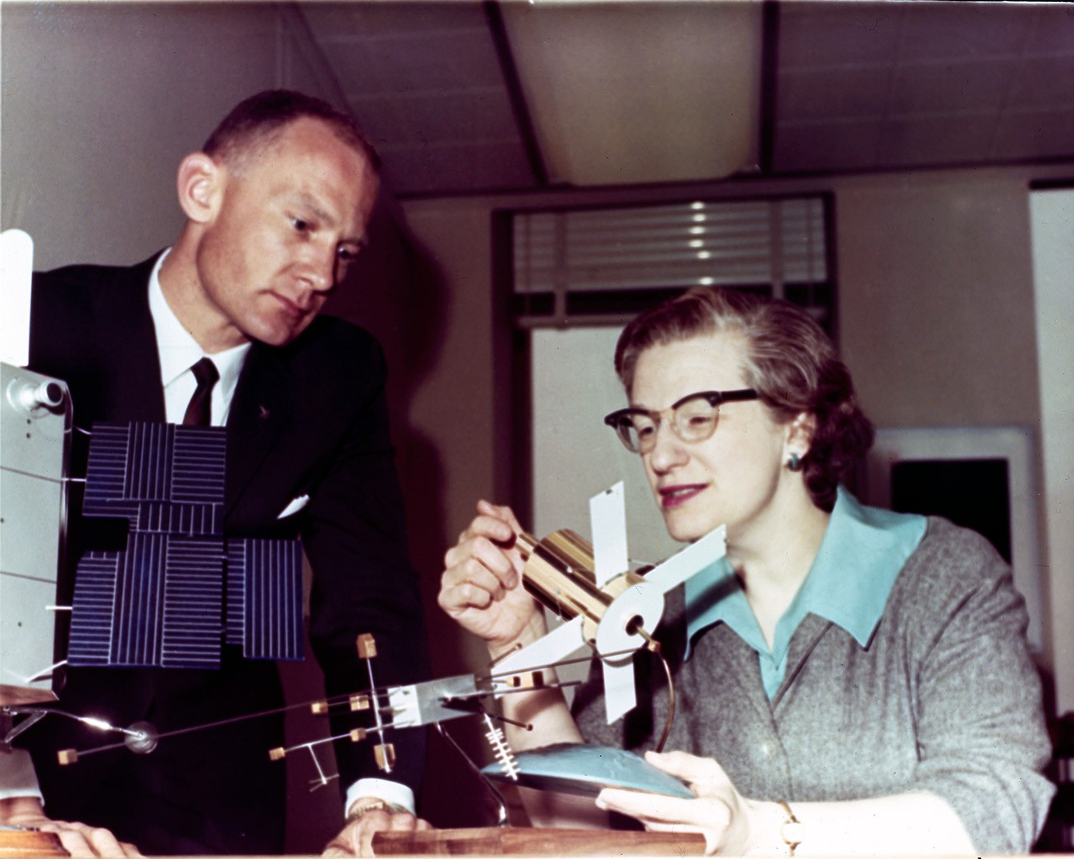Dr. Nancy Grace Roman explains the Advanced Orbiting Solar Observatory (AOSO) to Astronaut Buzz Aldrin using a model of the spacecraft.