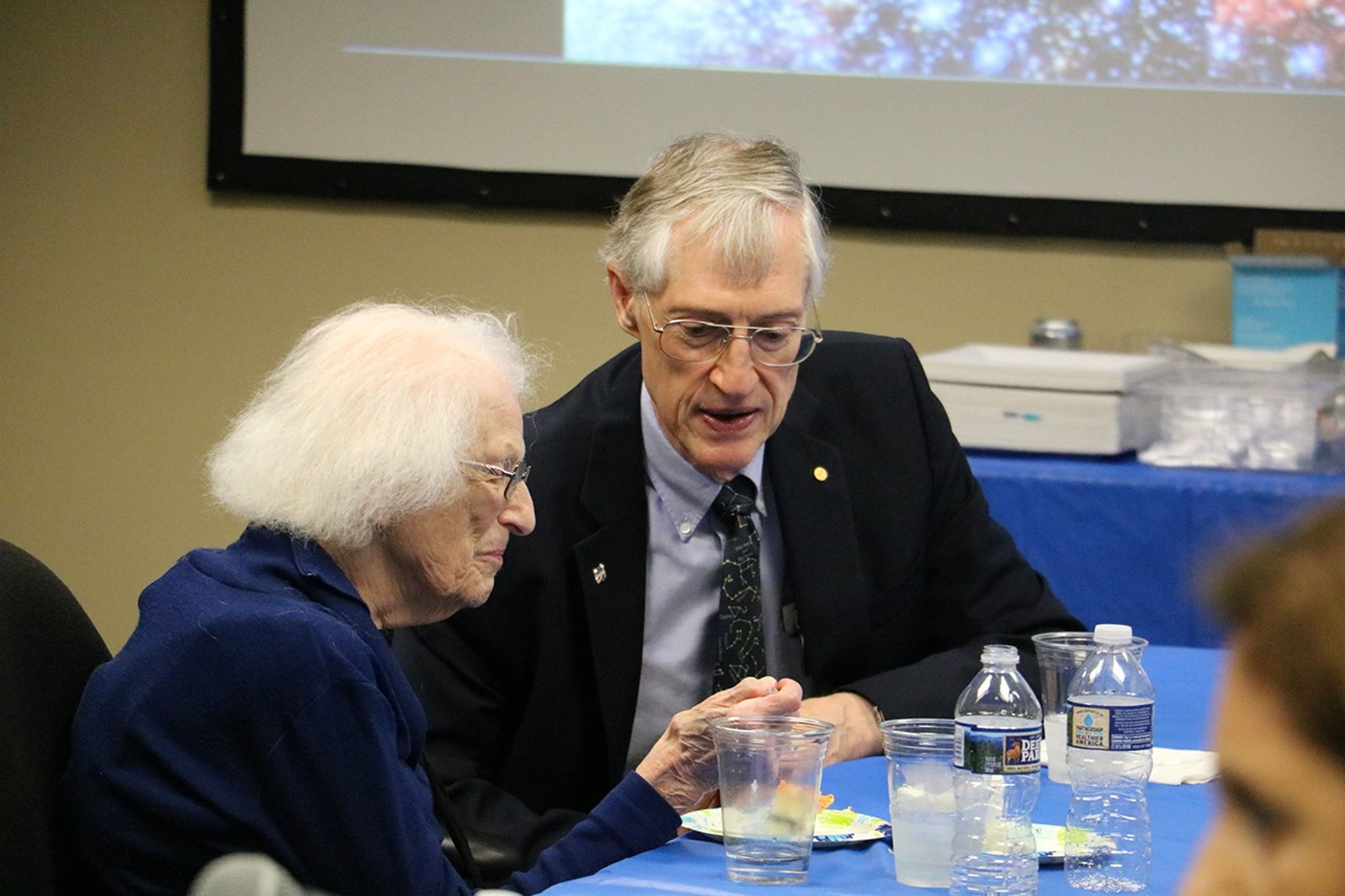 Nancy Grace Roman eating lunch and talking with John Mather.