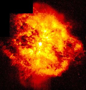 A yellow-and-red nebula resembling a fiery explosion surrounding a bright star on a black background.