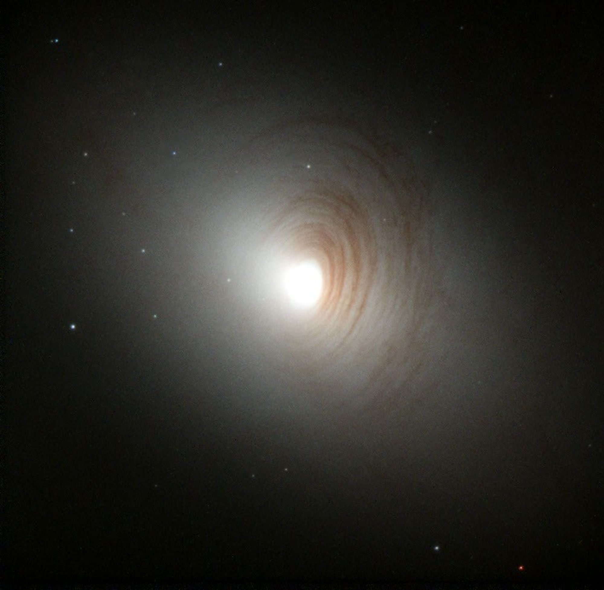 Tightly Wound Arms of Dust Encircle Nucleus of Galaxy NGC 2787