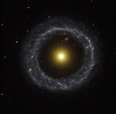 Ring of Hot Blue Stars Pinwheels Around Yellow Nucleus of Hoag’s Object Galaxy
