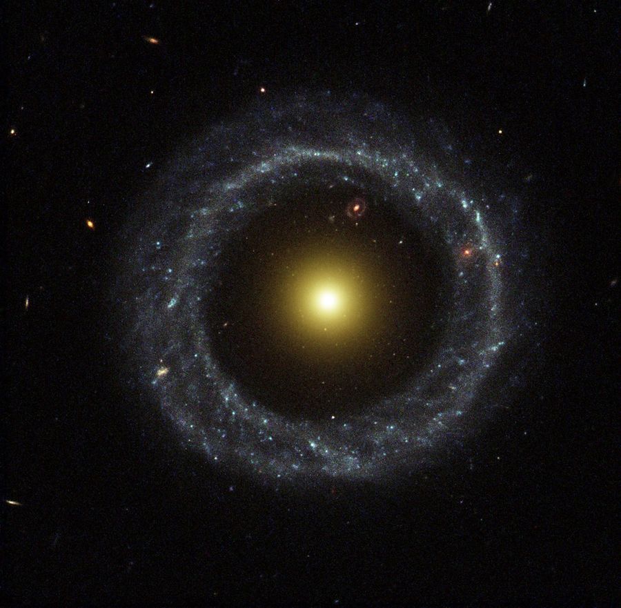 A large ring of circular blue stars surrounds a bright, large yellow nucleus, with a large gap between the ring and the nucleus.