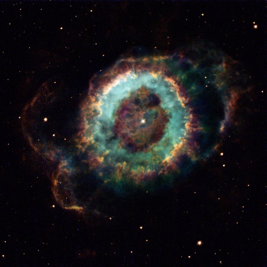 At the center is a single star surrounded by rings of mottled gas.