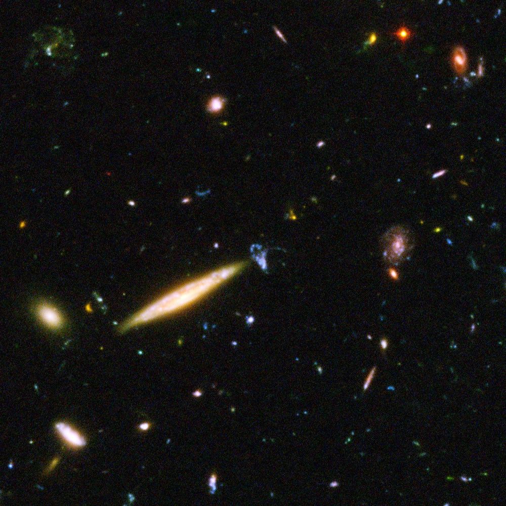 Edge-On Spiral Galaxy Collides With Small Blue Galaxy in Hubble Ultra Deep Field Image