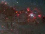 Bubbles of red and black material stretch across the image.