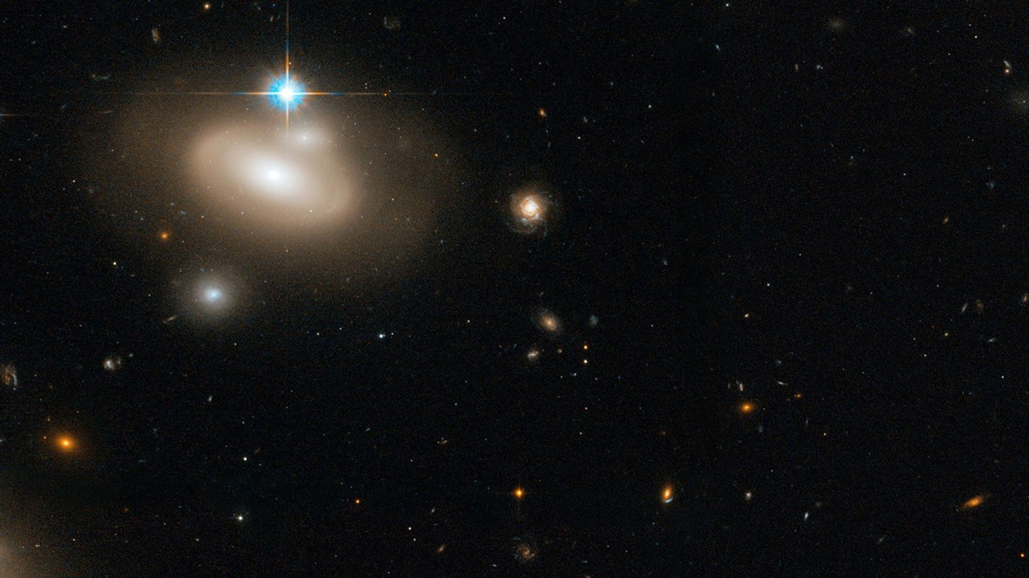 Lenticular Galaxy in the Coma Cluster with Numerous Background  Galaxies, a Detail of a Larger Hubble Image